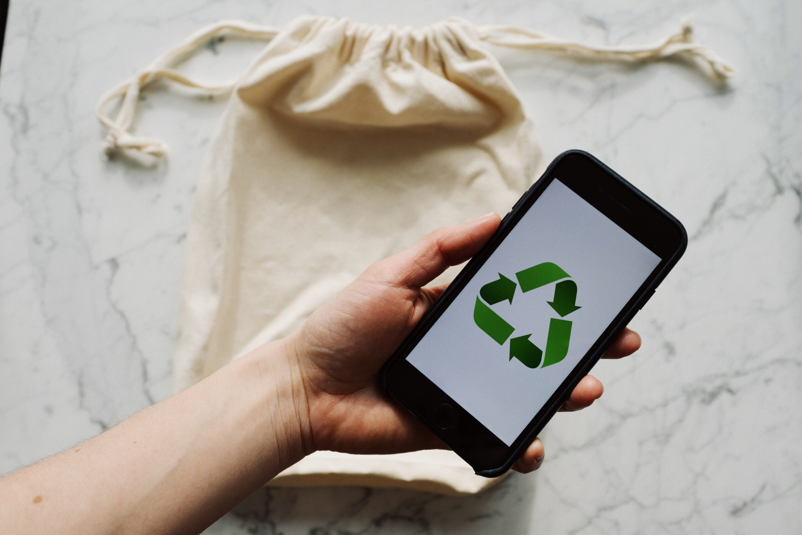 Showing E-waste recycle symbol on mobile phone screen Stock Photo