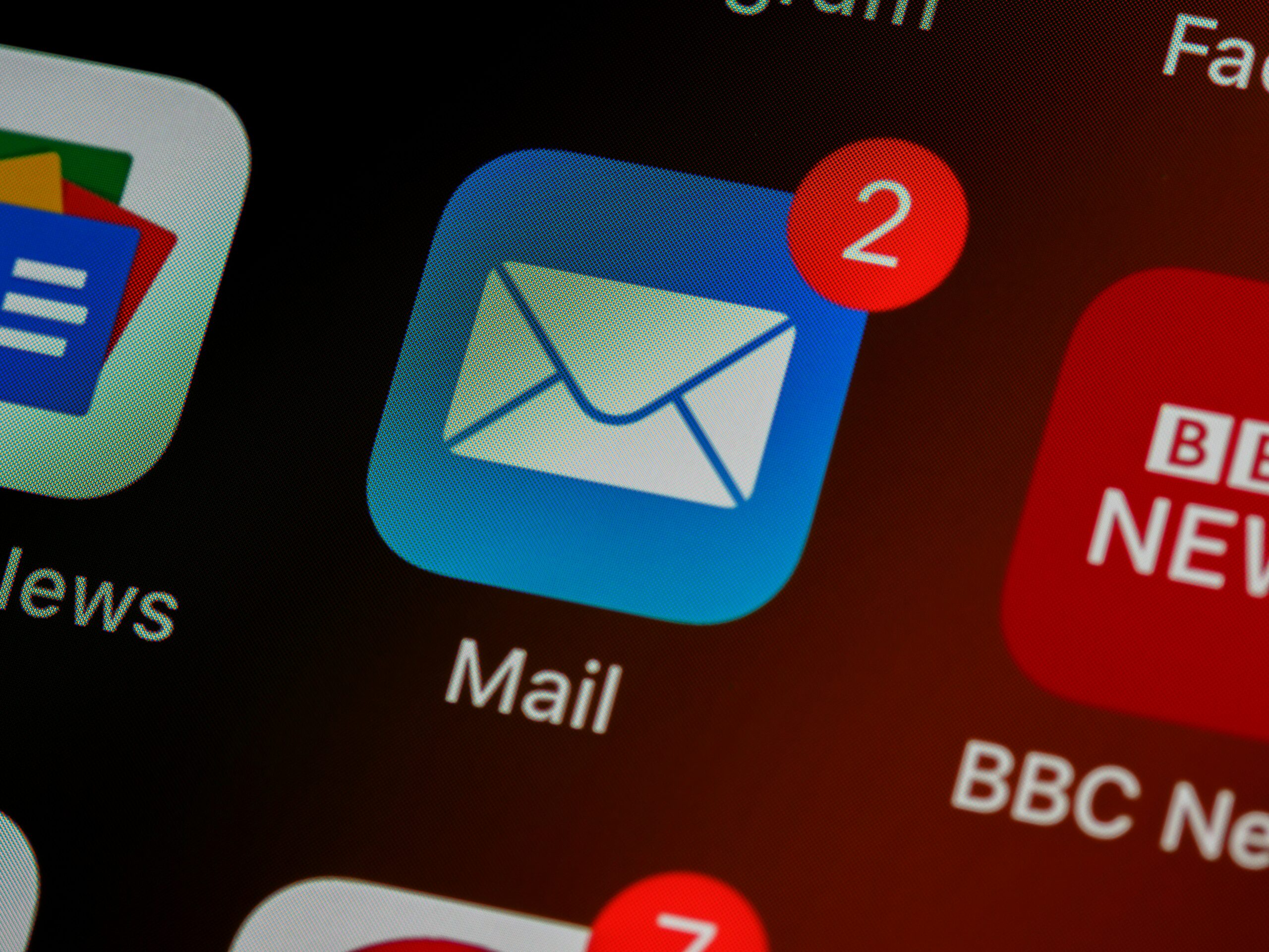 brett-jordan-LPZy4da9aRo-unsplash-scaled.jpg closeup of mail app icon on phone
